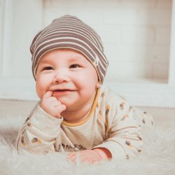 Smiling baby in a knit cap
