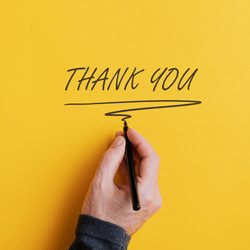 Hand writing thank you on a yellow card