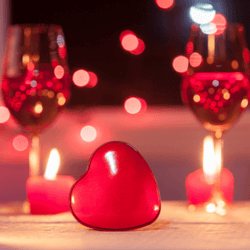 Red heart glowing on a table with soft lights behind it