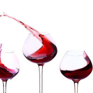 Wine glasses with swirling red wine